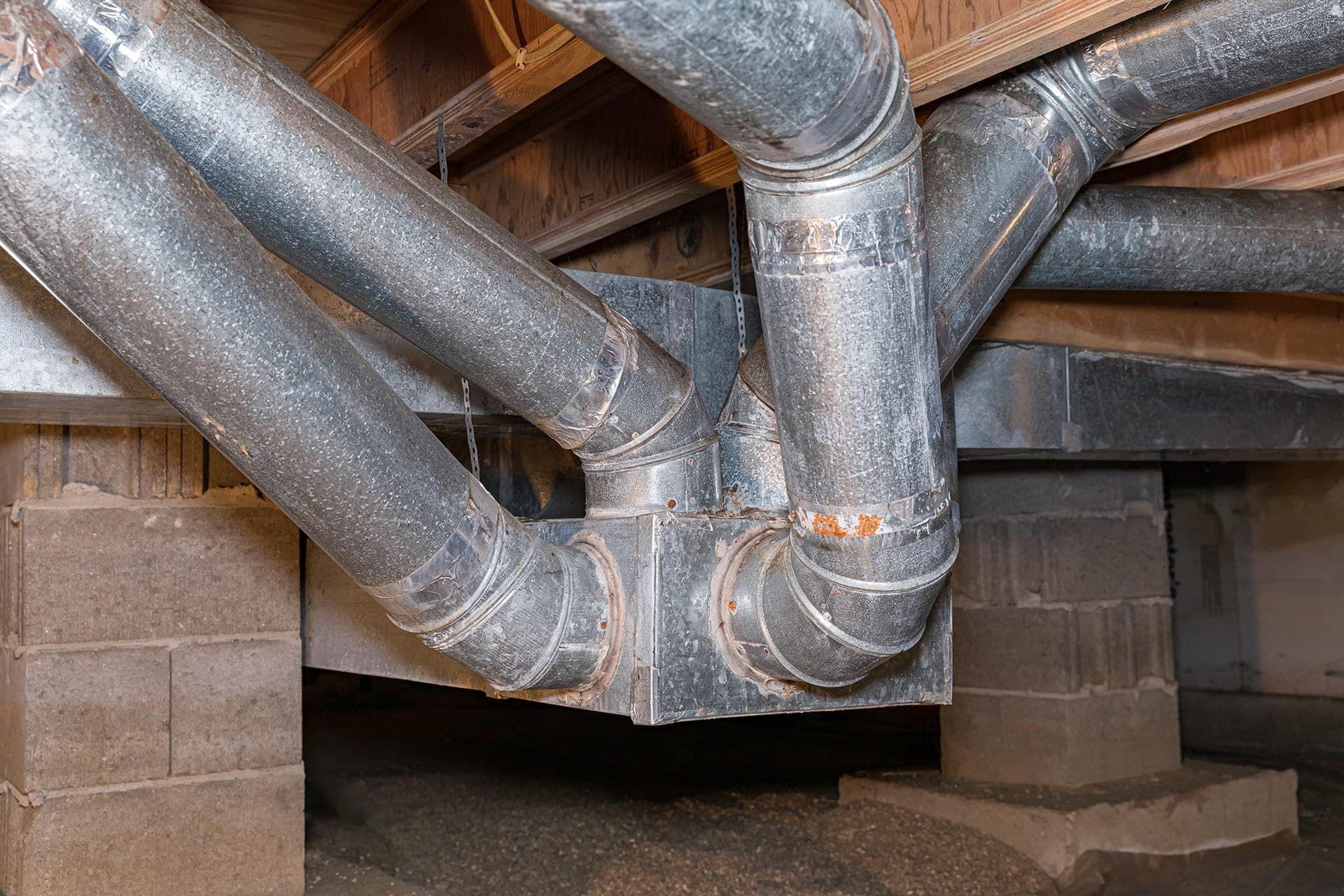 Basement ductwork system with metal pipes.
