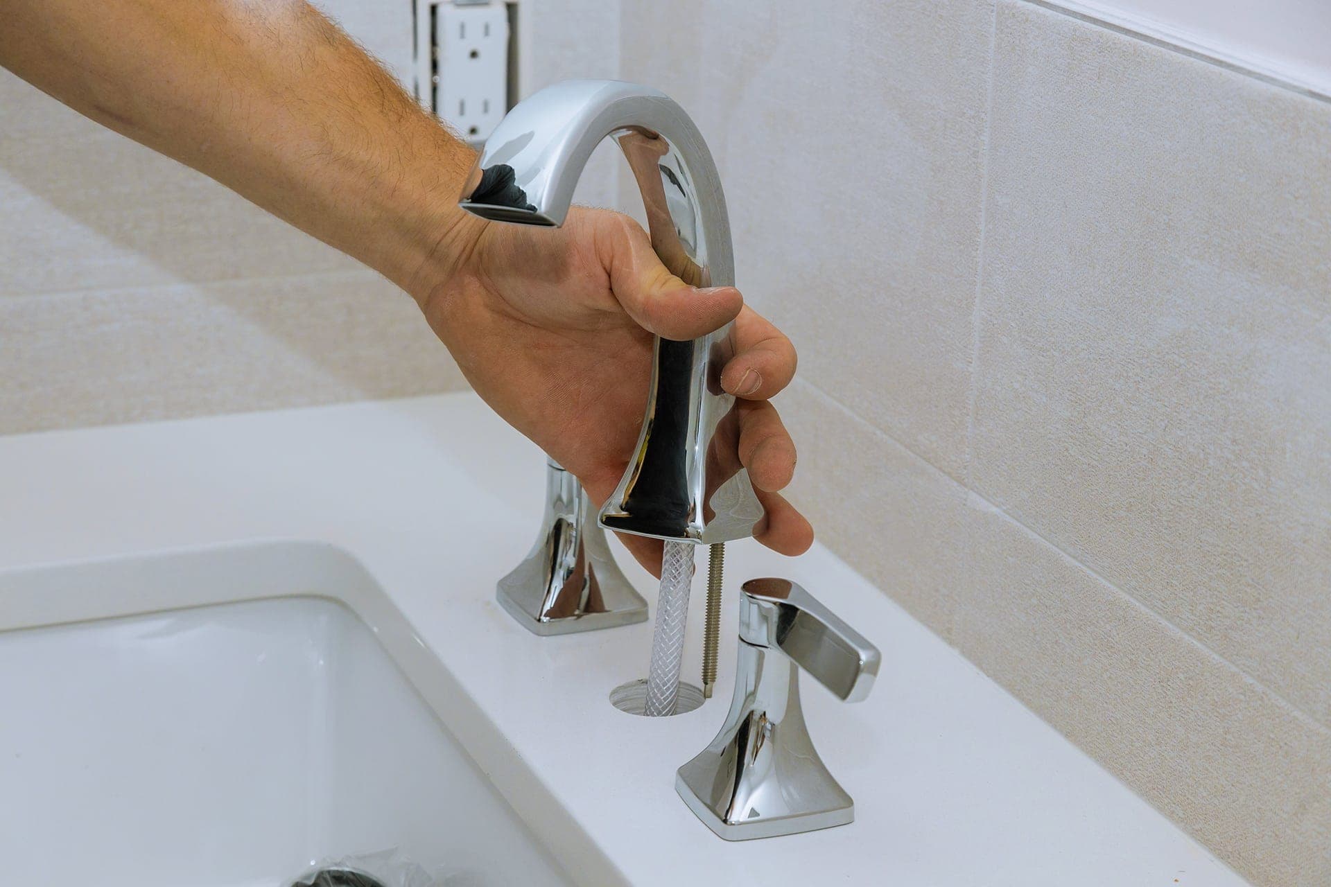 Installing a bathroom faucet by hand