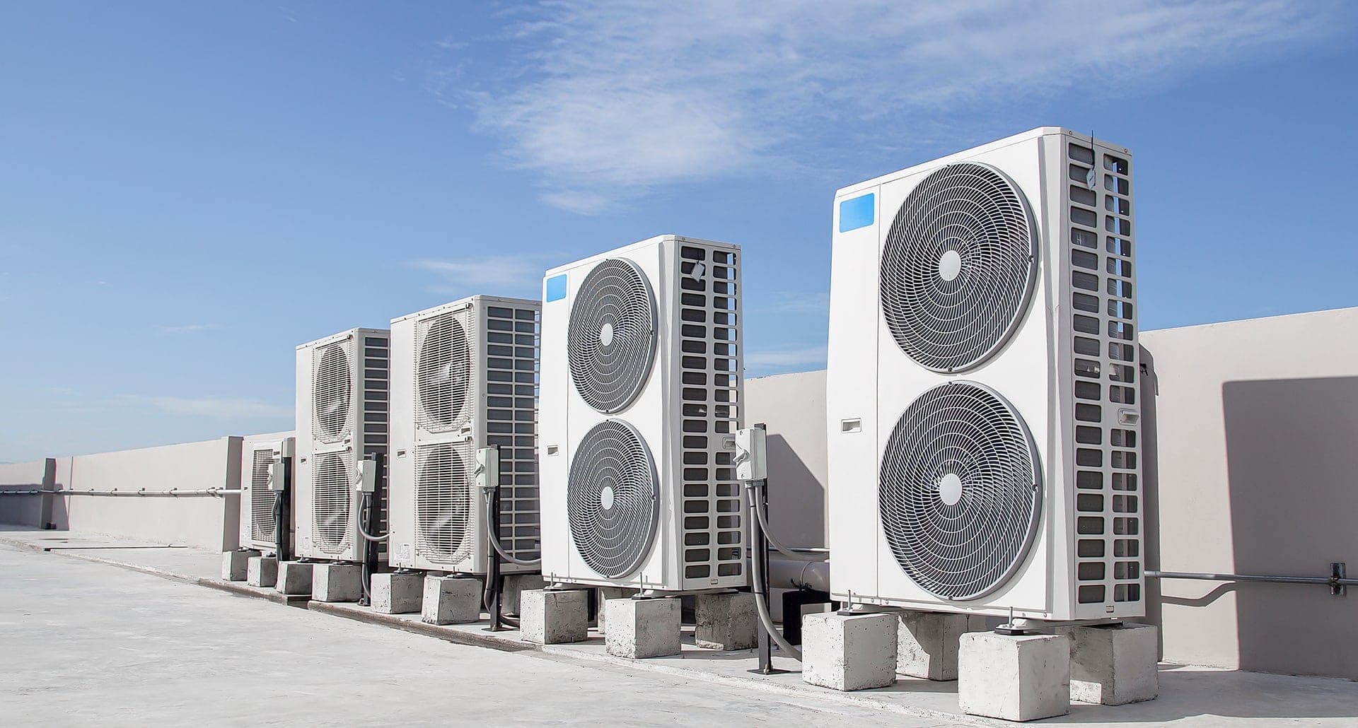Rooftop air conditioning units under a blue sky.